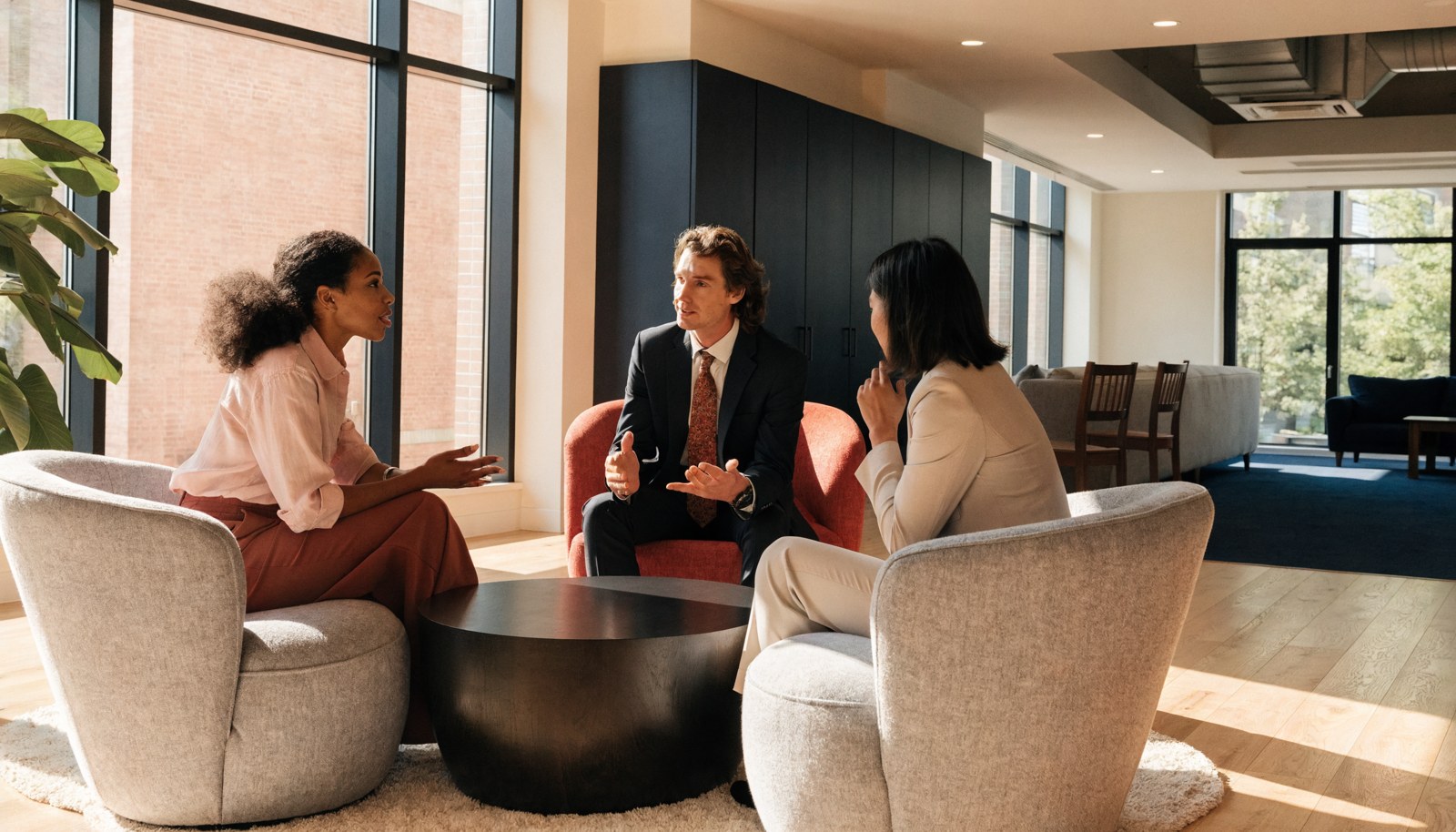 Professionals meeting in an office lounge.